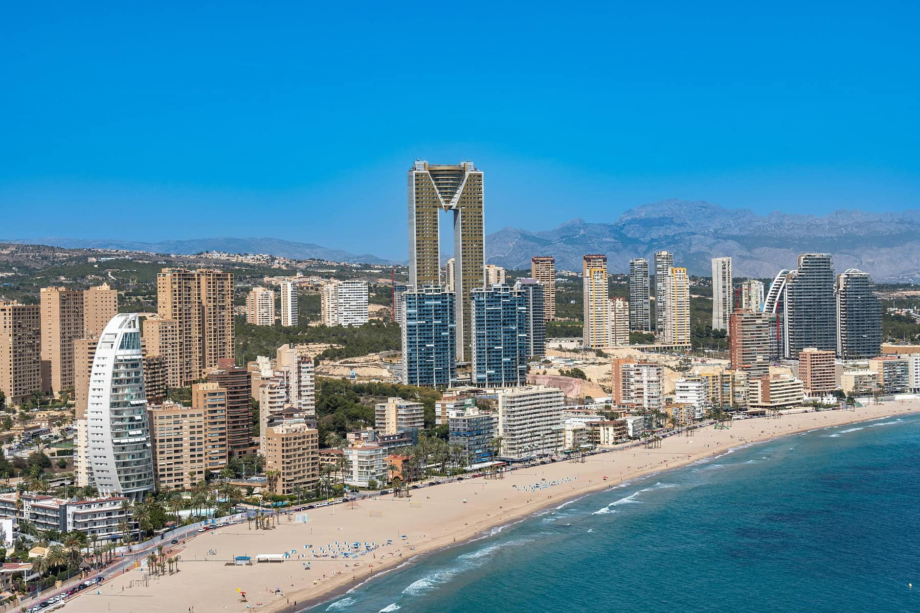Panoramic view of the luxury apartments in Benidorm Poniente skyline at sunset, resembling a Mediterranean Miami.